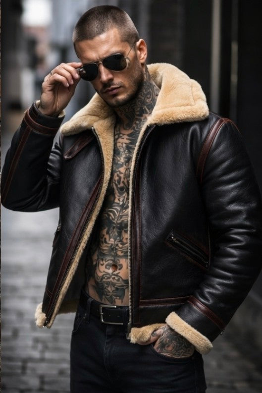 Man wearing a black leather jacket with shearling lining, sunglasses, and tattoos in an urban setting.